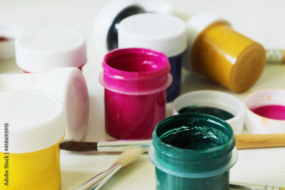 painting tools, mix of gouache paints and paintbrushes