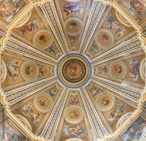 Interior view of richly decorated cupola of catholic cathedral in Rome