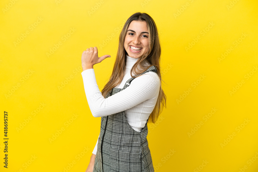 Young caucasian woman isolated on yellow background proud and self-satisfied Young caucasian woman isolated on yellow background proud and self-satisfied
