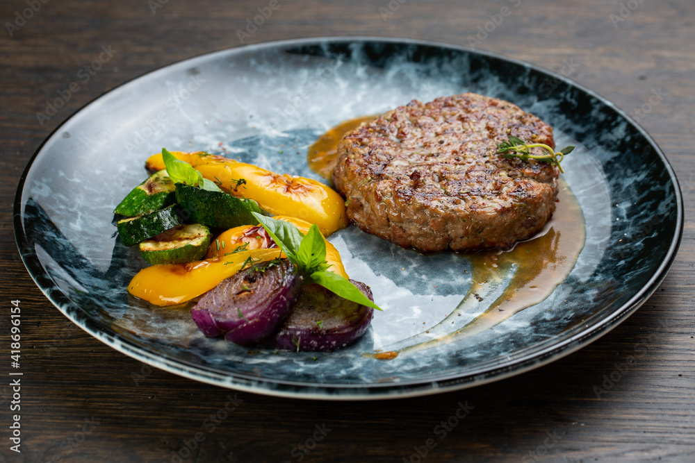 grilled minced beef cutlet with grilled vegetables and barbecue sauce. fried zucchini, onion and pepper with minced pork cutlet grilled minced beef cutlet with grilled vegetables and barbecue sauce. fried zucchini, onion and pepper with minced pork cutlet