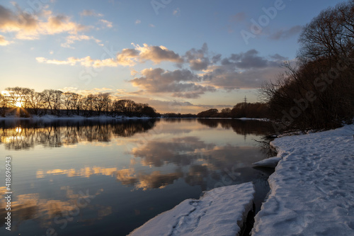Winter sunset rural river landscape. Sunset river in winter scene © Sergei