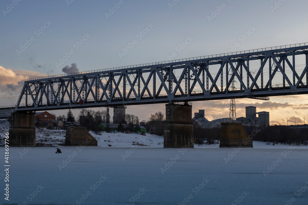 Fototapeta premium railway bridge winter. Railway bridge over the river. Steel structure, railway.