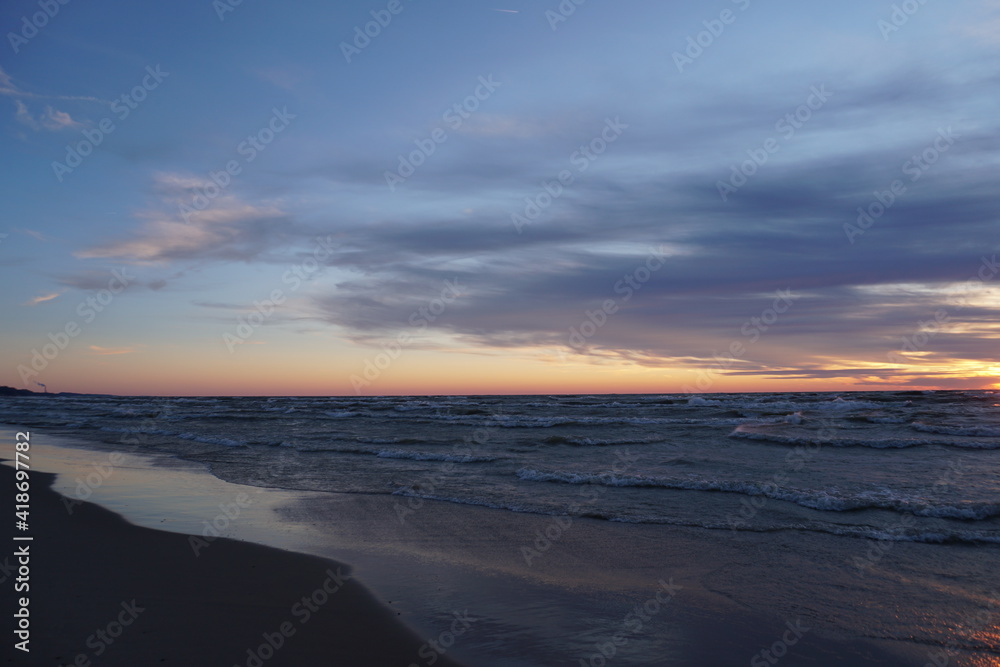 Beach shoreline along the lake at sunset