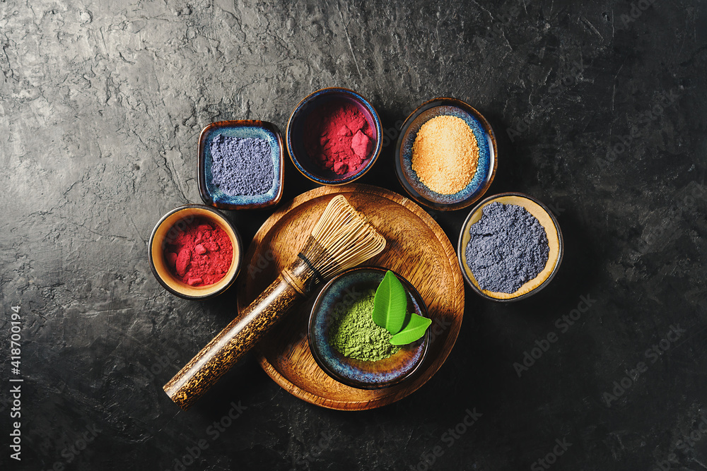 Various matcha tea powders on a dark concrete background. Top view. Various matcha tea powders on a dark concrete background. Top view.