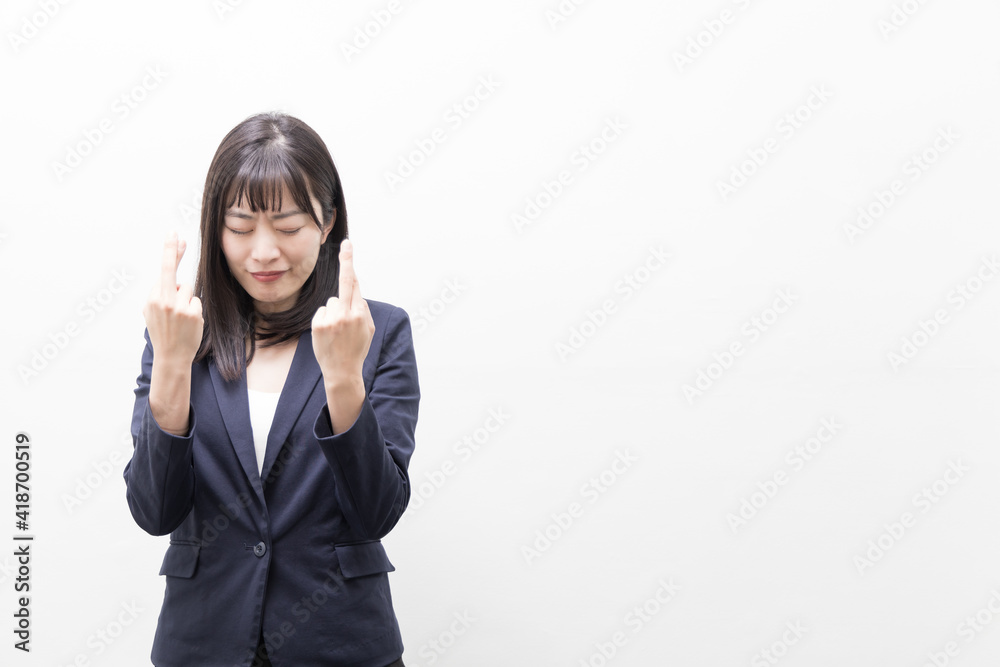 Woman standing and finger crossing (gesture) Woman standing and finger crossing (gesture)