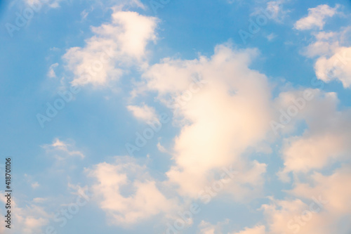 Scattered clouds of orangeyellow color and spring evening light Evening cloud background concept