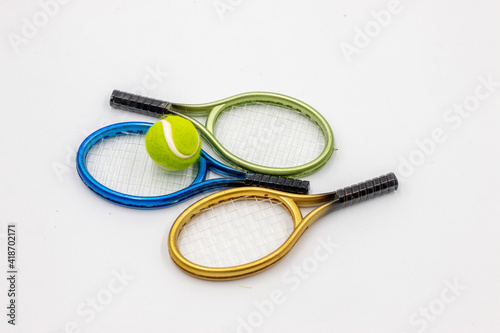 Tennis racket and ball are on white background