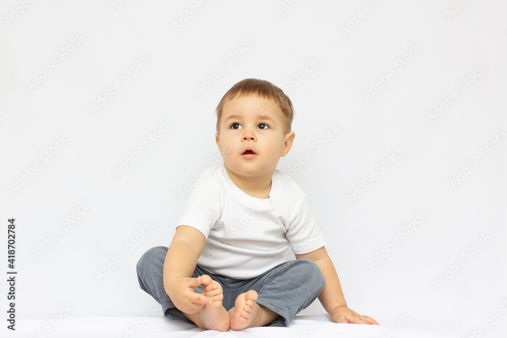 Happy baby. Little boy in a white shirt and pants Children portrait. Happy baby. Little boy in a white shirt and pants Children portrait.