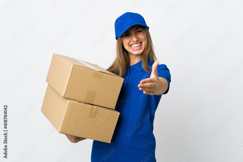 Young delivery woman over isolated white background shaking hands for closing a good deal Young delivery woman over isolated white background shaking hands for closing a good deal