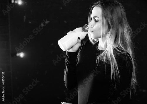 Young girl drinks milk from a bottle