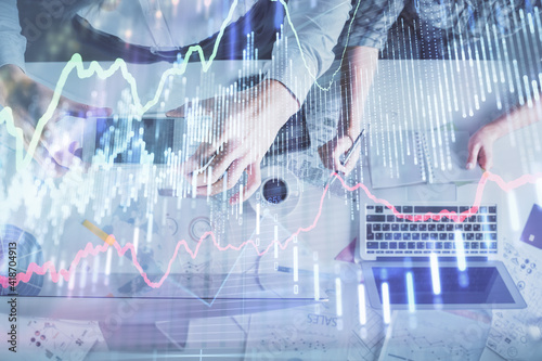 Double exposure of man and woman working together and financial chart hologram drawing. market analysis concept. Computer background. Top View.