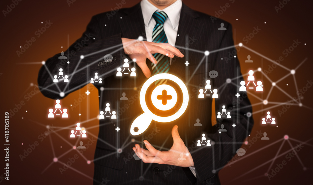 Hand holdig magnifying glass icon around his hands, Social networking concept Hand holdig magnifying glass icon around his hands, Social networking concept