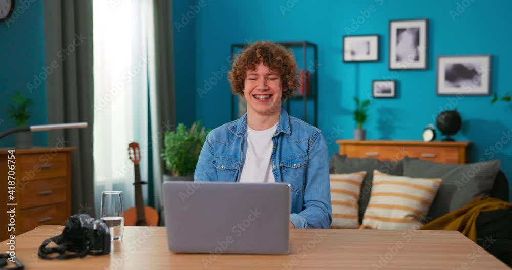Successful teenage boy sits at table uses laptop read e-mails online home office, gets good news, positive exam results, new opportunity, feels joy triomphe, celebrates victory, happy dancing Successful teenage boy sits at table uses laptop read e-mails online home office, gets good news, positive exam results, new opportunity, feels joy triomphe, celebrates victory, happy dancing