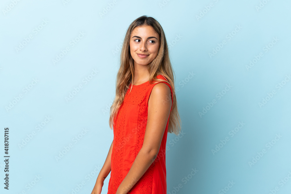 Young hispanic woman over isolated blue background . Portrait Young hispanic woman over isolated blue background . Portrait