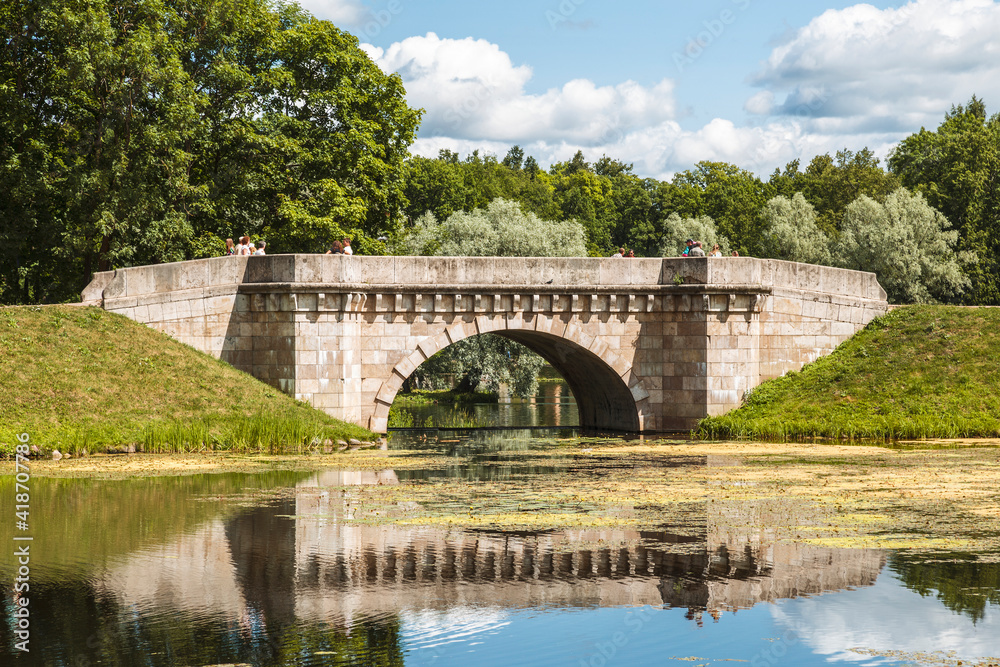 View of the Karpin Bridge in the Palace park of the Gatchina Museum-Reserve. Gatchina, Leningrad Region, Russia View of the Karpin Bridge in the Palace park of the Gatchina Museum-Reserve. Gatchina, Leningrad Region, Russia