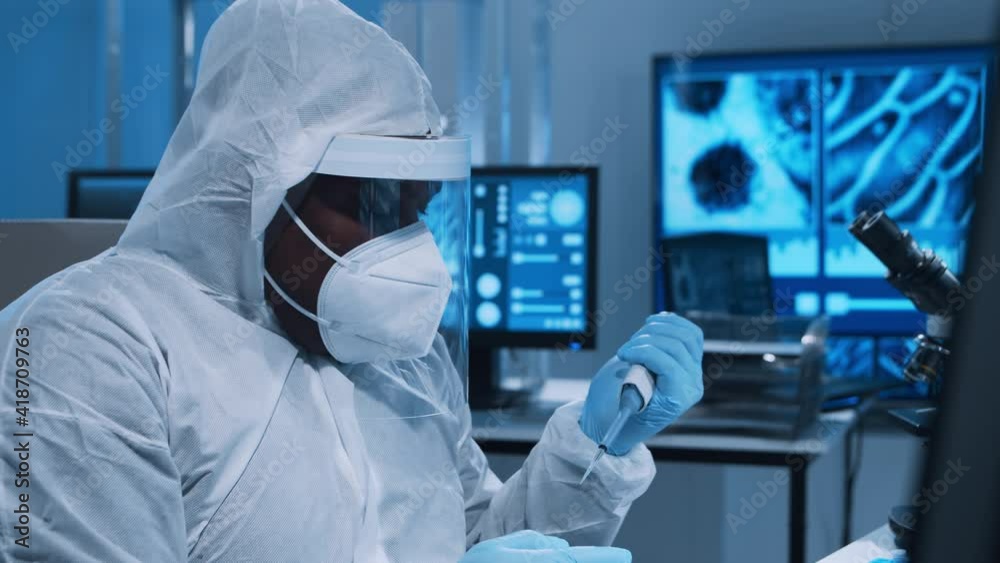 African-American doctor is doing a science experiments and developing vaccine in a modern laboratory. Genetic engineers workplace. The concept of science and medicine. African-American doctor is doing a science experiments and developing vaccine in a modern laboratory. Genetic engineers workplace. The concept of science and medicine.