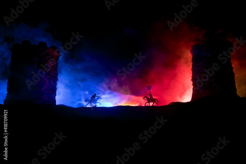 Medieval battle scene. Silhouettes of figures as separate objects, fight between warriors at night. Creative artwork decoration. Foggy background.