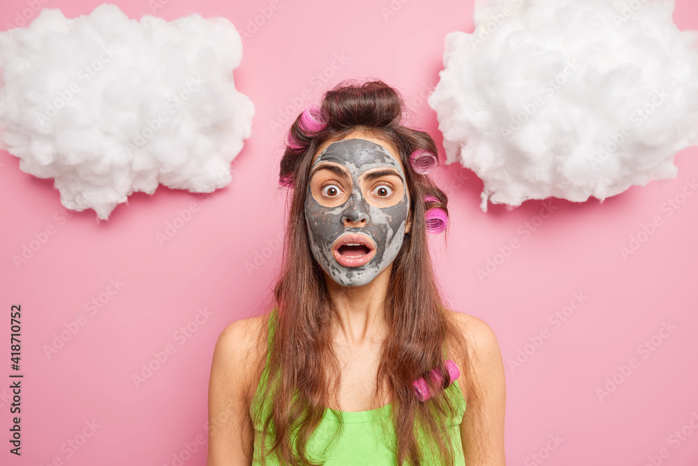 Surprised young European woman stares shocked at camera keeps jaw