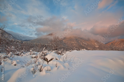 Majestic sunset in the winter mountains landscape. Dramatic sky. Azerbaijan nature.