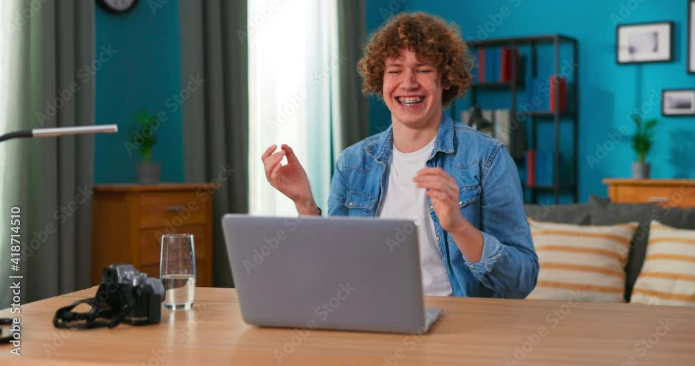 Successful teenage boy sits at table uses laptop read e-mails online home office, gets good news, positive exam results, new opportunity, feels joy triomphe, celebrates victory, happy dancing Successful teenage boy sits at table uses laptop read e-mails online home office, gets good news, positive exam results, new opportunity, feels joy triomphe, celebrates victory, happy dancing