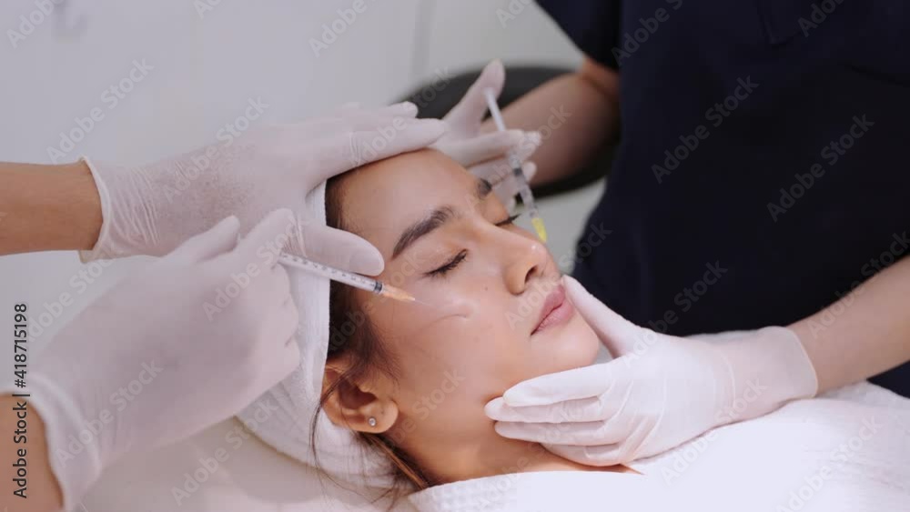 Cosmetologist doctor is making multiple injections biorevitalization with hyaluronic acid in woman face skin on cheek, closeup. Beautician on mesotherapy and face lifting procedure . Cosmetologist doctor is making multiple injections biorevitalization with hyaluronic acid in woman face skin on cheek, closeup. Beautician on mesotherapy and face lifting procedure .