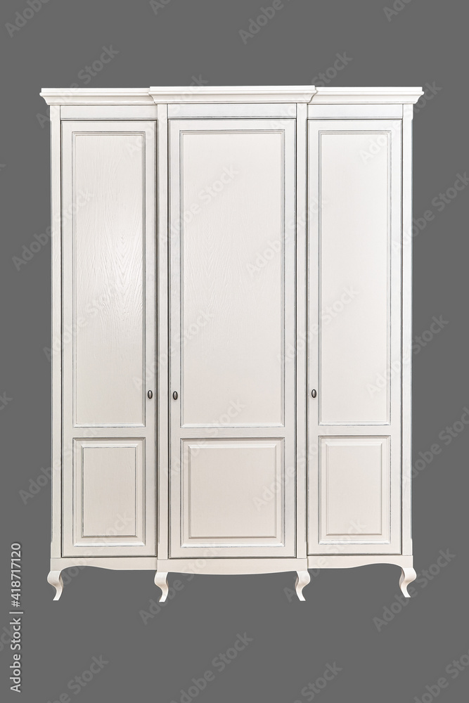 Three-section white wardrobe in classic style with carved legs isolated on grey background Three-section white wardrobe in classic style with carved legs isolated on grey background