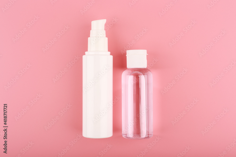 Set of cosmetic bottles for face cream or lotion and skin lotion or gel against pink background. Concept of skin care and beauty Set of cosmetic bottles for face cream or lotion and skin lotion or gel against pink background. Concept of skin care and beauty
