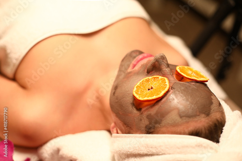Woman lying in spa salon with moisturizing mask on her face. Skin care concept