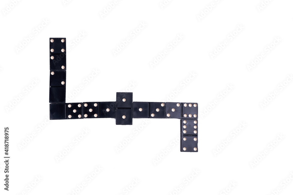 black Domino dice on a white table, the process of playing dominoes. Close up. Selective focus. black Domino dice on a white table, the process of playing dominoes. Close up. Selective focus.