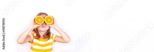 A narrow photo of a beautiful girl looking up with orange halves near her eyes. © Kseniia Ovsiankina