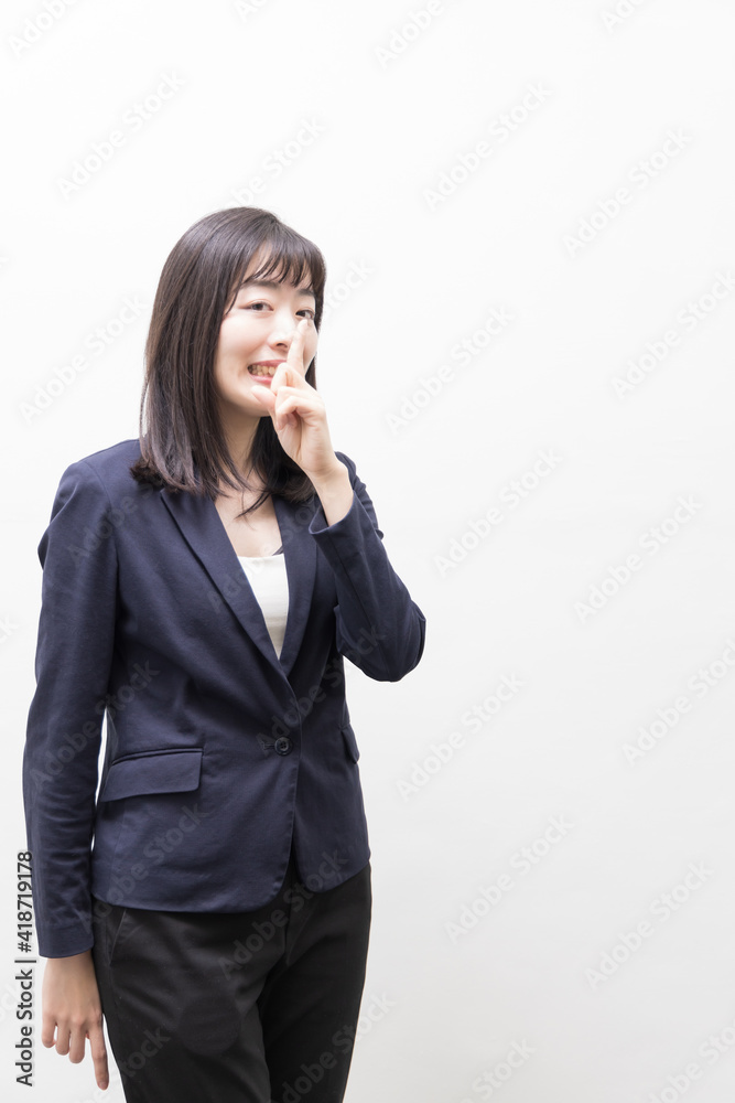 Woman raises her index finger in front of her mouth (gesture) Woman raises her index finger in front of her mouth (gesture)