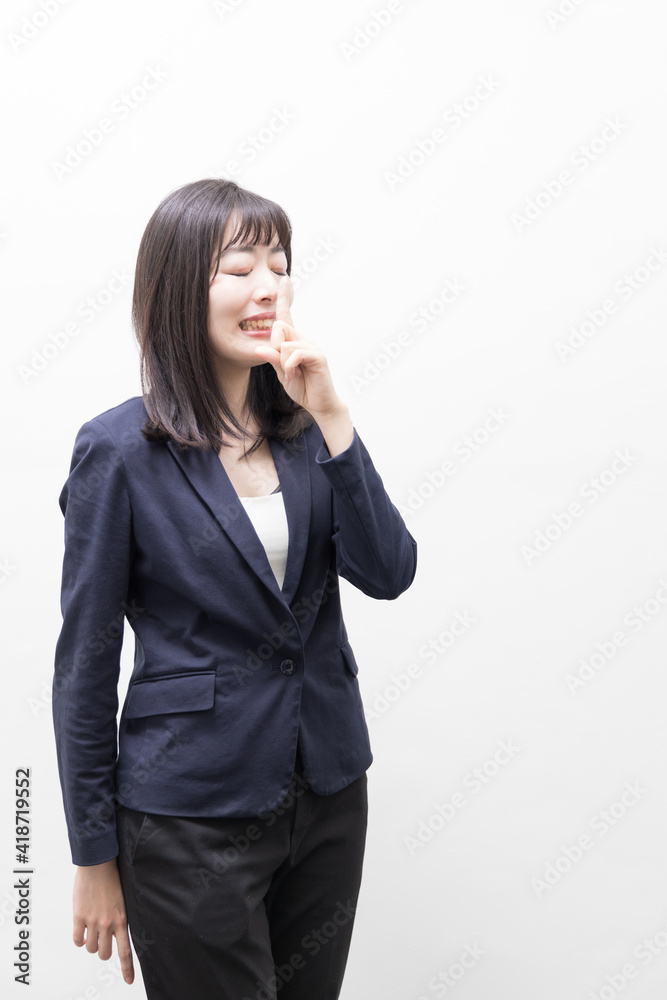 Woman raises her index finger in front of her mouth (gesture) Woman raises her index finger in front of her mouth (gesture)