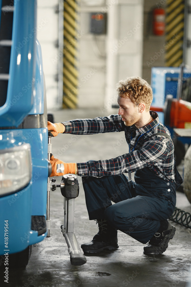 Man in uniform. Truck repair. Car malfunction