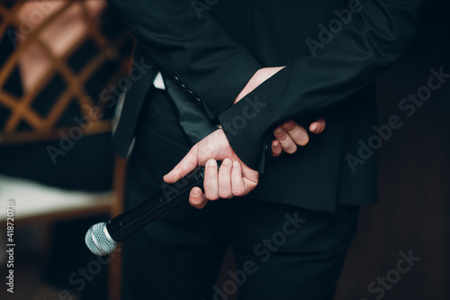 Man Showman Speaker Holding Microphone Behind His Back Business Conference Concept