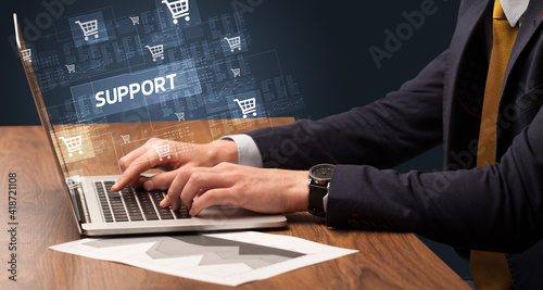 Businessman working on laptop with SUPPORT inscription, online shopping concept