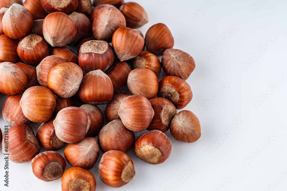 fresh natural hazelnuts on a white acrylic background fresh natural hazelnuts on a white acrylic background