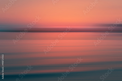 Abstract sunset sky background with motion blurred gradient lines. Orange  pink  and deep green color. 