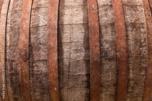 Old beer barrel. Background of a trunk and a worn old wooden table. 