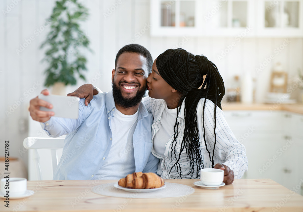 Selfie Time. Cheerful Black Guy Taking Photo With His Girlfriend In Kitchen Selfie Time. Cheerful Black Guy Taking Photo With His Girlfriend In Kitchen