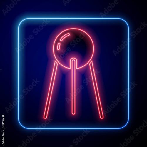Glowing neon Satellite icon isolated on blue background. Vector.