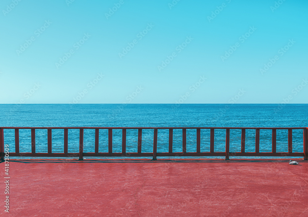 Beautiful background from the sea pier with a view of the blue sky and the sea horizon. Calm seascape.