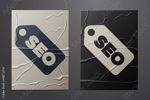 White SEO optimization icon isolated on crumpled paper background. Paper art style. Vector.