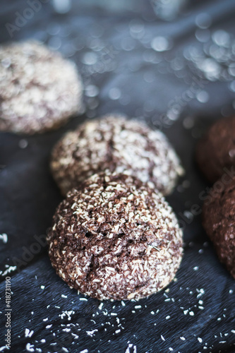 Chocolate chip cookies with coconut. Lie on a black and gray background.