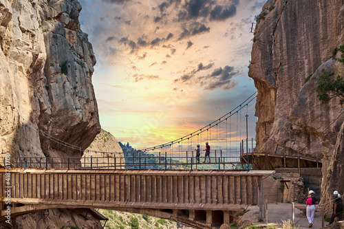 Very narrow bridge in rocky canyon - mountain wooden path along steep cliffs in Andalusia, Spain