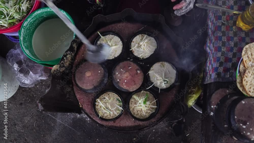 Top view wide shot street cook makes banh xeo traditional Vietnamese squid pancake Top view wide shot street cook makes banh xeo traditional Vietnamese squid pancake