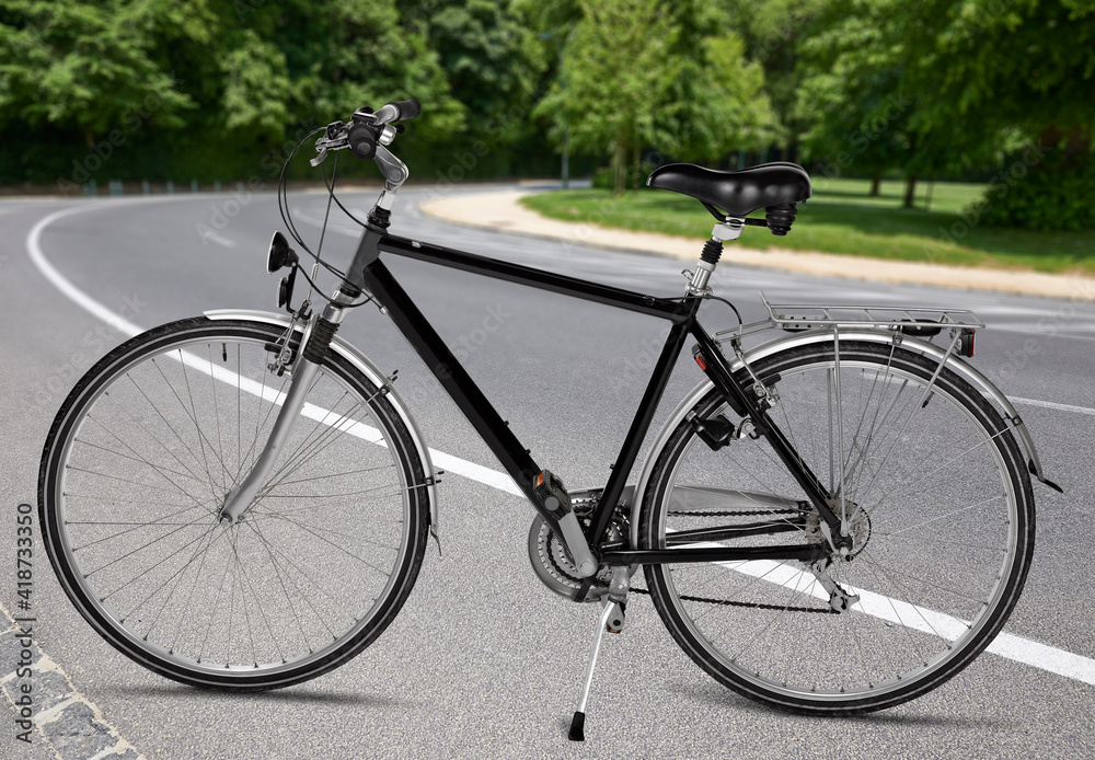 Fototapeta premium Black road bike standing on road from public park
