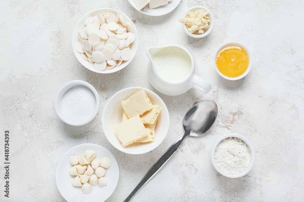 Chocolate drops and ingredients for bakery on light background Chocolate drops and ingredients for bakery on light background