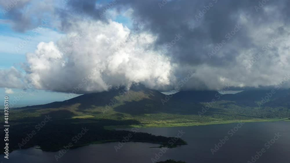 Arenal volcano aerial view lake reservoir clouds Costa Rica Arenal volcano aerial view lake reservoir clouds Costa Rica