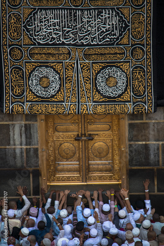 The door of the Kaaba - Multazam. Muslim pilgrims in motion in front of the door of the holy Kaaba. photo