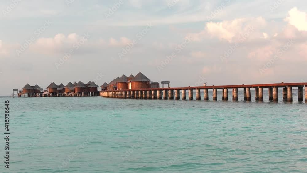 shot of island resort in the Maldives. Private villas over the turquoise water shot of island resort in the Maldives. Private villas over the turquoise water